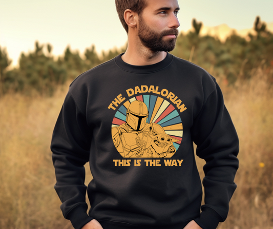 The Dadalorian crewneck sweatshirt features a bold graphic design inspired by the iconic phrase “This is the Way” from the Star Wars universe. Crafted with soft, durable fabric, this shirt is a perfect Father’s Day gift for any proud dad. Whether worn by a girl dad or a father with a special needs child, it celebrates the unique journey of fatherhood. The design combines humor, fandom, and love, making it an ideal addition to any dad’s wardrobe. 🌟👕